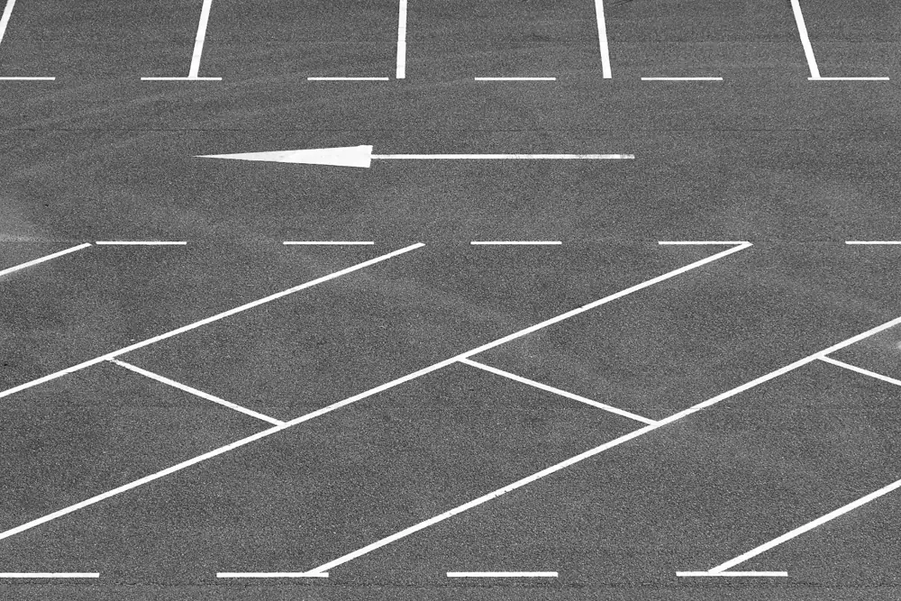 Painted pavement markings and directional arrow in a commercial lot